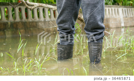 Men wear black boots for a flood. 36465871