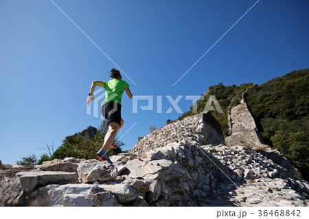 woman trail runner running at mountain top woman trail runner running at mountain top 36468842