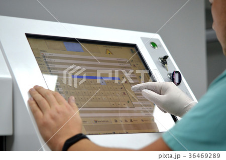 The man works on the machine sensory monitor The man works on the machine sensory monitor 36469289