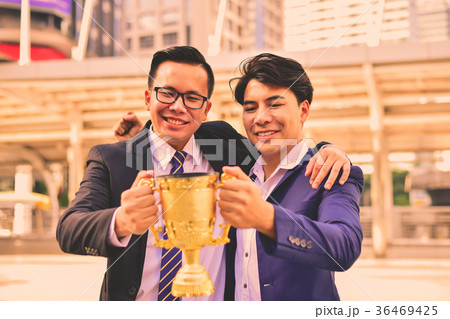 Young businessmen are competing for wins and trophies. 36469425