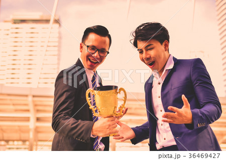 Young businessmen are competing for wins and trophies. 36469427
