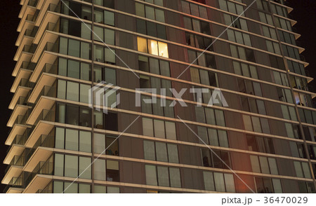 Single lit window in an apartment block at night Single lit window in an apartment block at night 36470029