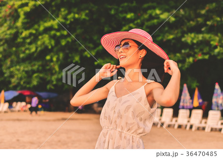Beautiful girl is walking on the beach happily. 36470485