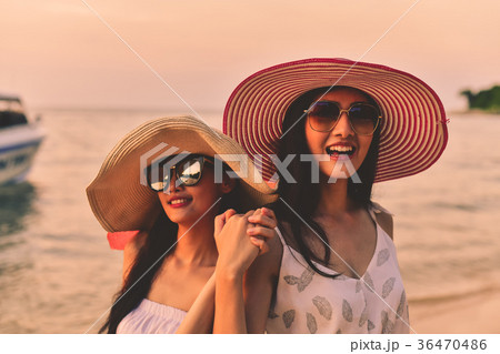 Beautiful girl is walking on the beach happily. 36470486