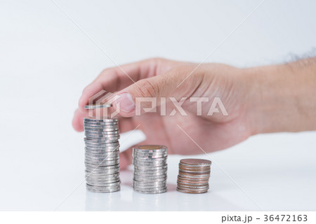 hand putting coin on white background 36472163