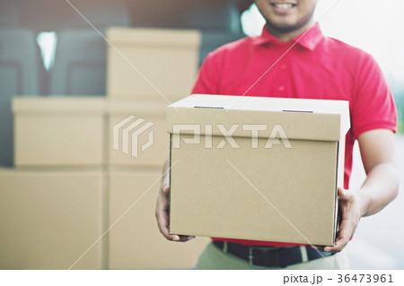 Smiling young male postal delivery courier man  36473961