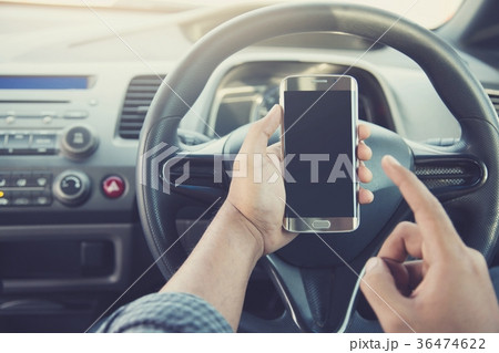 using smart phone mobile phone in car.	 using smart phone mobile phone in car.	 36474622
