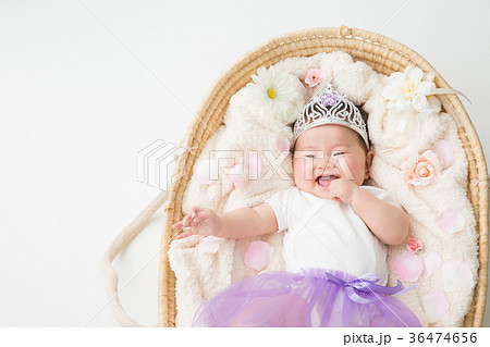 おもちゃの王冠をかぶる赤ちゃん 笑顔 の写真素材