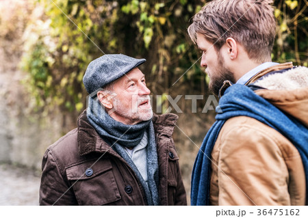 Senior father and his young son on a walk. 36475162