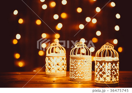 Christmas lantern with burning candles and garland 36475745