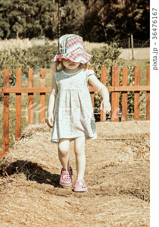 Little girl is walking on the haystack, filter Little girl is walking on the haystack, filter 36476167