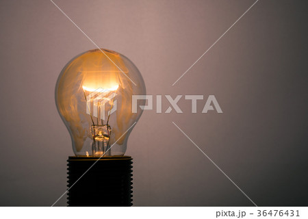Single glass bulb mounted in socket with flame  36476431