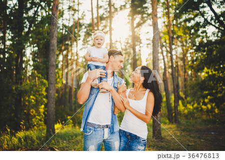 stylish young Family mom, dad and daughter 1 year stylish young Family mom, dad and daughter 1 year 36476813
