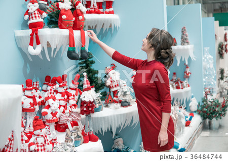 customer girl choosing gifts for Christmas and New customer girl choosing gifts for Christmas and New 36484744