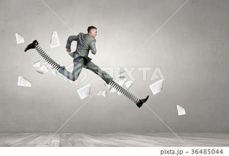 Businessman making wide jump Businessman making wide jump 36485044