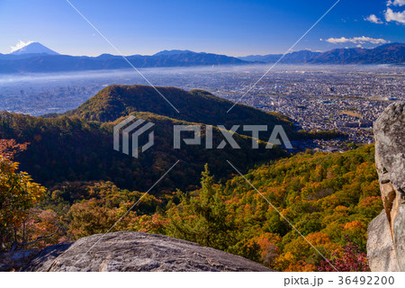 山梨県 紅葉の和田峠から富士山と甲府盆地を望むの写真素材