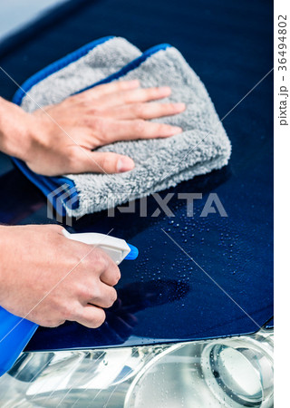 Hands cleaning car with spray cleaner and Hands cleaning car with spray cleaner and 36494802
