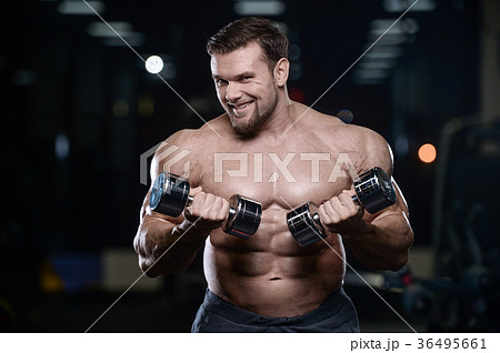 Brutal strong bodybuilder athletic men pumping up muscles with d Brutal strong bodybuilder athletic men pumping up muscles with d 36495661
