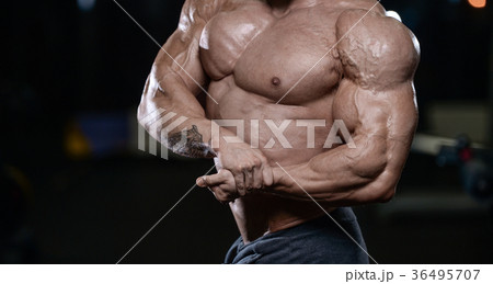Brutal strong bodybuilder athletic men pumping up muscles with d Brutal strong bodybuilder athletic men pumping up muscles with d 36495707