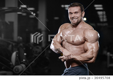 Brutal strong bodybuilder athletic men pumping up muscles with d Brutal strong bodybuilder athletic men pumping up muscles with d 36495708