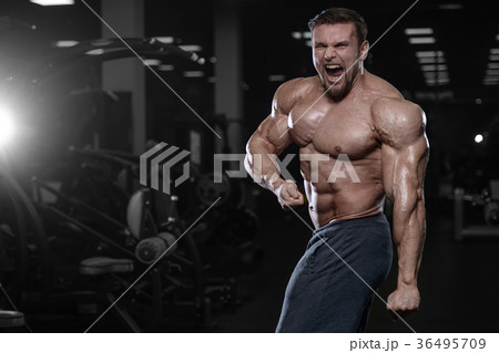 Brutal strong bodybuilder athletic men pumping up muscles with d Brutal strong bodybuilder athletic men pumping up muscles with d 36495709