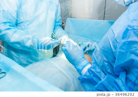 hands of surgeon and an assistant with instruments 36496202