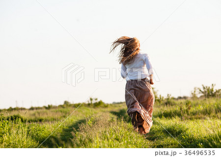 The girl ran across the field 36496535