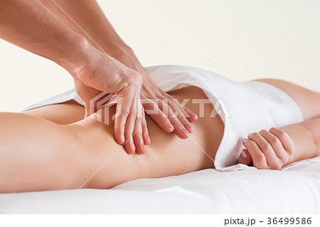 Detail of hands massaging human calf muscle. 36499586