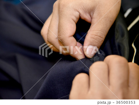 hands of Tailor man working in his cloth fabric  36500353