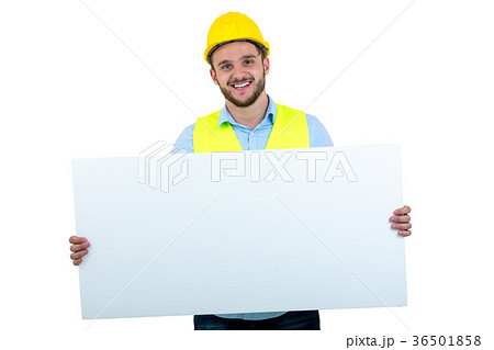 Happy male engineer holding an advertisement blank Happy male engineer holding an advertisement blank 36501858