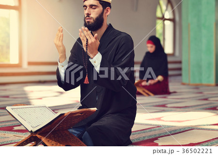 Muslim man and woman praying for Allah in the 36502221