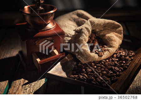Coffee mill on dark rustic background. Wood table Coffee mill on dark rustic background. Wood table 36502768