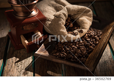 Coffee mill on dark rustic background. Wood table 36502769
