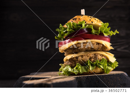Double Burger on the board on beautiful black Double Burger on the board on beautiful black 36502771