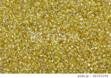 Background of golden yellow glass beads. 36503240