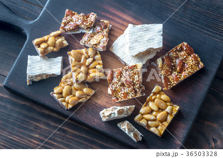 Slices of turron on the wooden board 36503328
