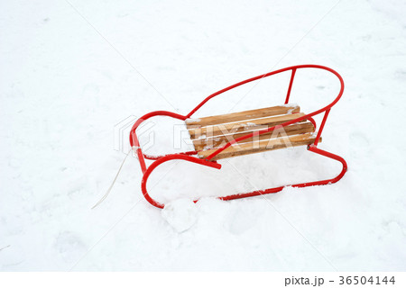 wooden sled on the snow - copy space wooden sled on the snow - copy space 36504144