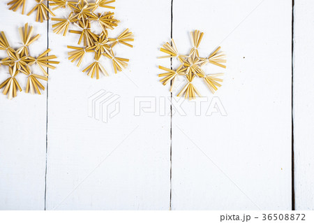 Brown snowflakes on a wooden background. 36508872