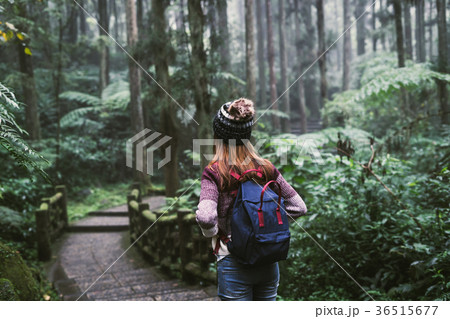 Young woman traveler walking in the forest 36515677