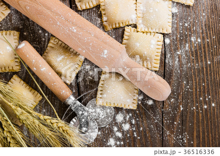 Raw ravioli on wooden background Raw ravioli on wooden background 36516336