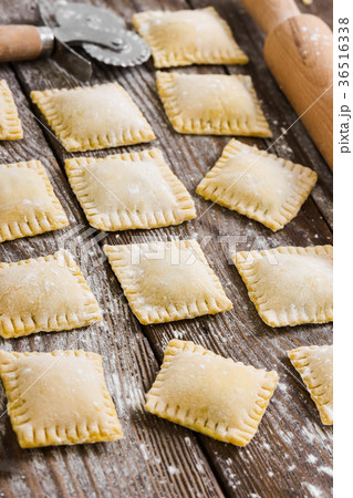 Raw ravioli on wooden background Raw ravioli on wooden background 36516338