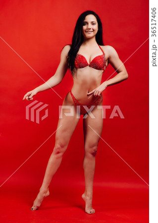beautiful young girl fitness model stands on red beautiful young girl fitness model stands on red 36517406
