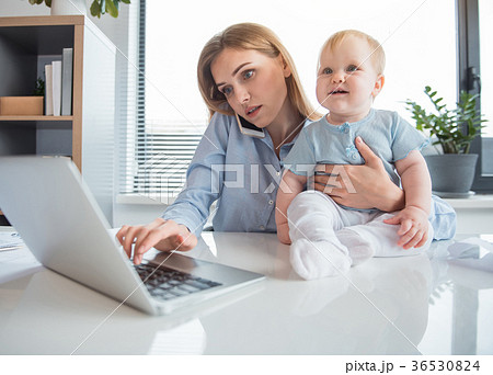 Serious businesswoman having job with kid Serious businesswoman having job with kid 36530824