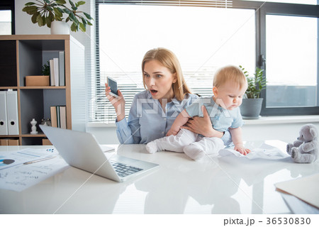 Surprised mother watching at laptop Surprised mother watching at laptop 36530830