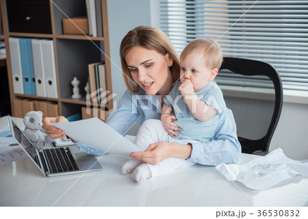 Beaming mother working at table with kid Beaming mother working at table with kid 36530832