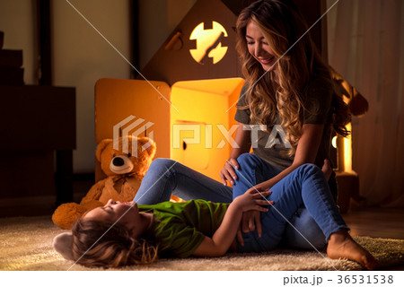 Cheerful family playing together near toy house Cheerful family playing together near toy house 36531538