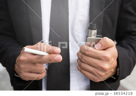 Businessman is smoking a cigarette. Businessman is smoking a cigarette. 36534219