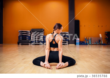 Yoga training, woman doing stretching exercise Yoga training, woman doing stretching exercise 36535788