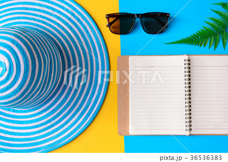 Blue hat and sunglasses on colorful paper 36536383