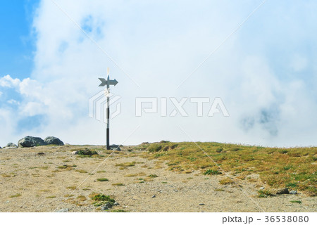 A signpost direction white sign arrow near A signpost direction white sign arrow near 36538080